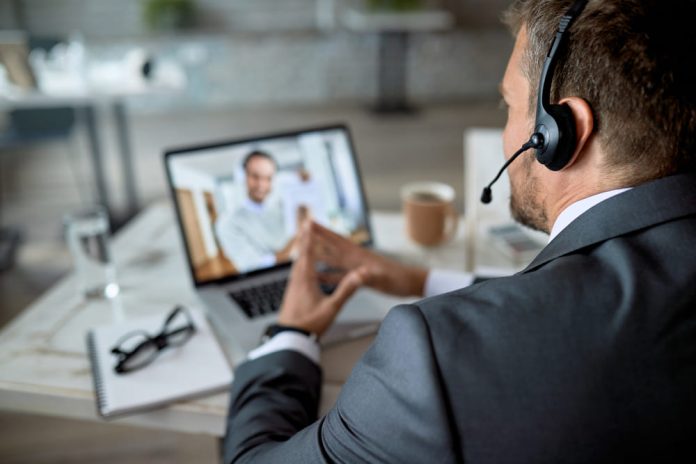 closeup-entrepreneur-using-laptop-while-having-online-business-meeting-office
